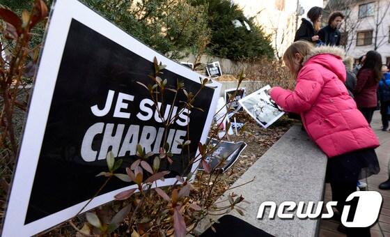 11일 오후 서울 서초구 반포4동 은행나무공원에서 열린 프랑스 파리 언론인 테러 추모행사에서 참가자들이 &#39;내가 샤를리다&#40;Je suis Charlie&#41;&#39;라는 팻말을 공원 모퉁이에 올려놓고 있다. 이날 이들은 희생자를 애도하며 어떠한 경우에도 표현의 자유는 억압 받아서는 안된다고 말했다. 2015.1.11/뉴스1 ⓒ News1 박지혜 기자