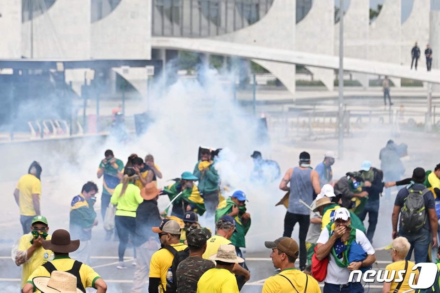 8일 &#40;현지시간&#41; 브라질리아에서 자이르 보우소나루 전 브라질 대통령 지지자가 대통령 궁 앞에서 경찰과 충돌을 하고 있다. ⓒ AFP=뉴스1 ⓒ News1 우동명 기자