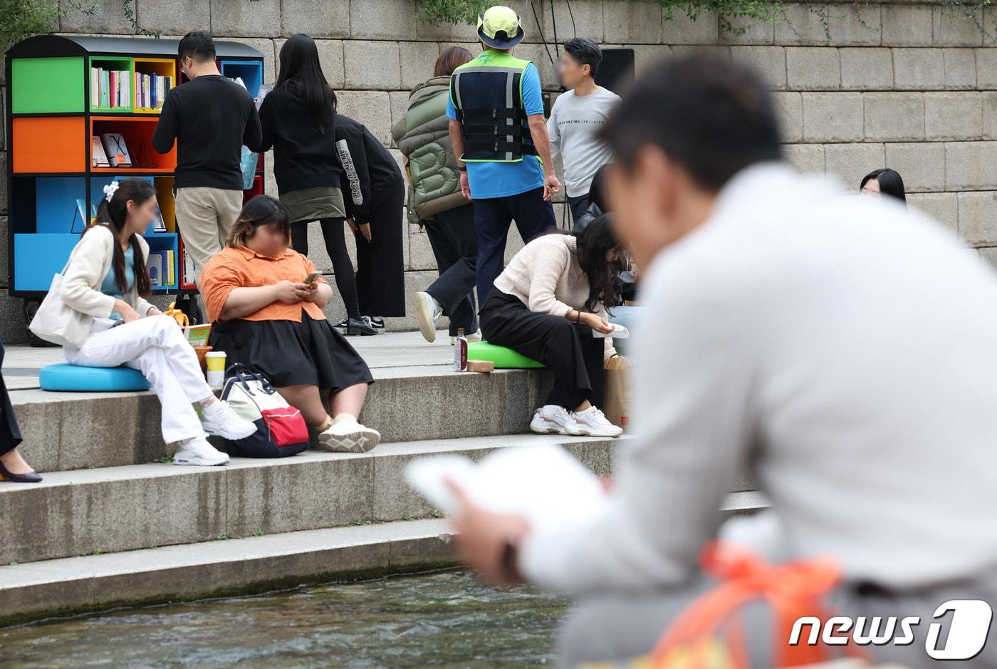 서울 중구 청계천에서 시민들이 책을 읽고 있다. /뉴스1 ⓒ News1 김민지 기자