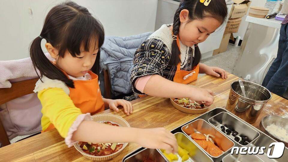 학산초등학교&#40;교장 정공순&#41;- 29일 학생들이 직접 기른 유기농 쌀을 활용해 쌀피자를 만들고 있다. 학생들은 마을과 협력한 &#39;학산들교육과정&#39;을 운영하며 볍씨관찰, 모판 제작, 추수 등 벼의 한살이와 다양한 유통·경제활동을 경험행했다.&#40;전남교육청 제공&#41;/뉴스1 