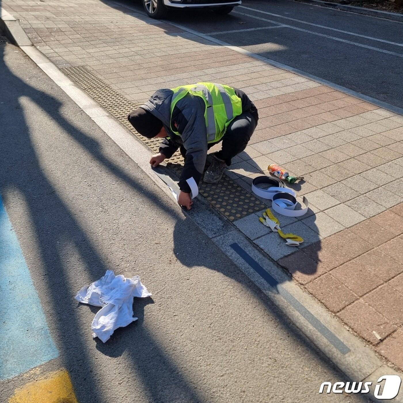 강원 영월군이 최근 지역 내 차도와 횡단보도 경계석에 미끄럼방지 테이프를 부착하는 모습. &#40;영월군 제공&#41; 2023.12.12/뉴스1