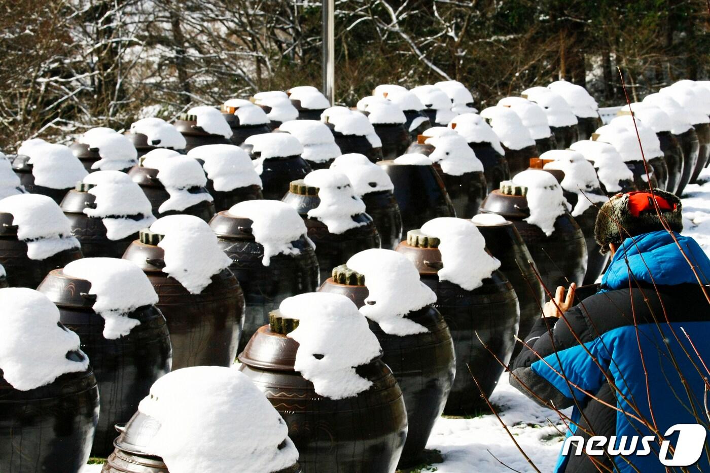 광주전남에 내려진 대설주의보가 17일 오전 10시를 기해 해제된 가운데 화순 만연사를 찾은 신도들이 스마트폰에 설경을 담고 있다. 2023.12.17/뉴스1 ⓒ News1 김태성 기자