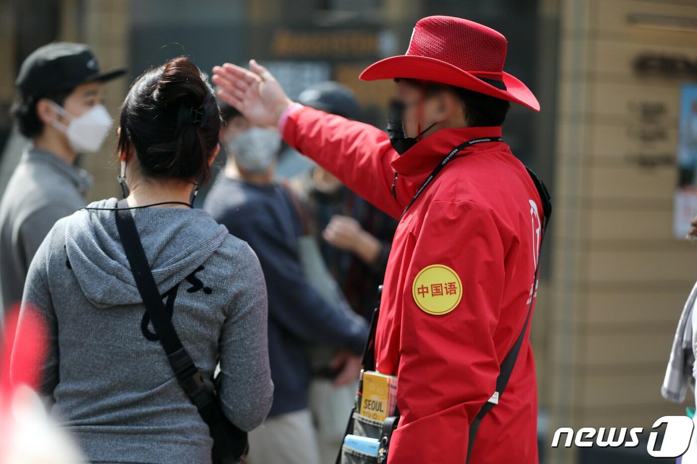 10일 오후 서울 중구 명동거리에서 외국인 관광객이 관광안내소 직원의 안내를 받고 있다. 지난 1일 중국발 입국자에 대한 유전자증폭&#40;PCR&#41; 진단검사 의무가 해제되면서 명동, 동대문 등 관광지에 중국인 관광객이 서서히 돌아오고 있다. 여행업계는 &#34;오는 11일부터 중국·홍콩·마카오발 입국자의 입국 전 검사 및 큐코드 의무화 조치가 사라진다.며 ＂4월 청명절, 노동절 연휴 때는 많은 중국 관광객이 방문할 것으로 본다고＂ 전했다. 2023.3.10/뉴스1 ⓒ News1 황기선 기자