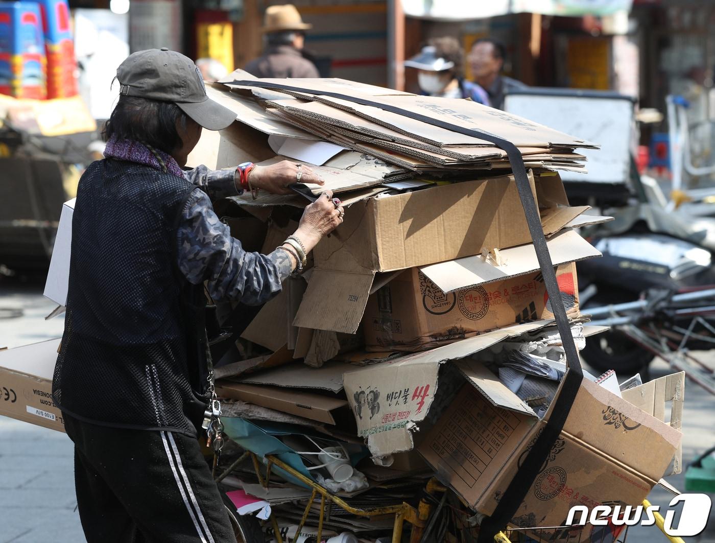 고물상 앞에서 한 노인이 리어카에 쌓인 폐지를 정리하고 있다. /뉴스1 ⓒ News1 신웅수 기자