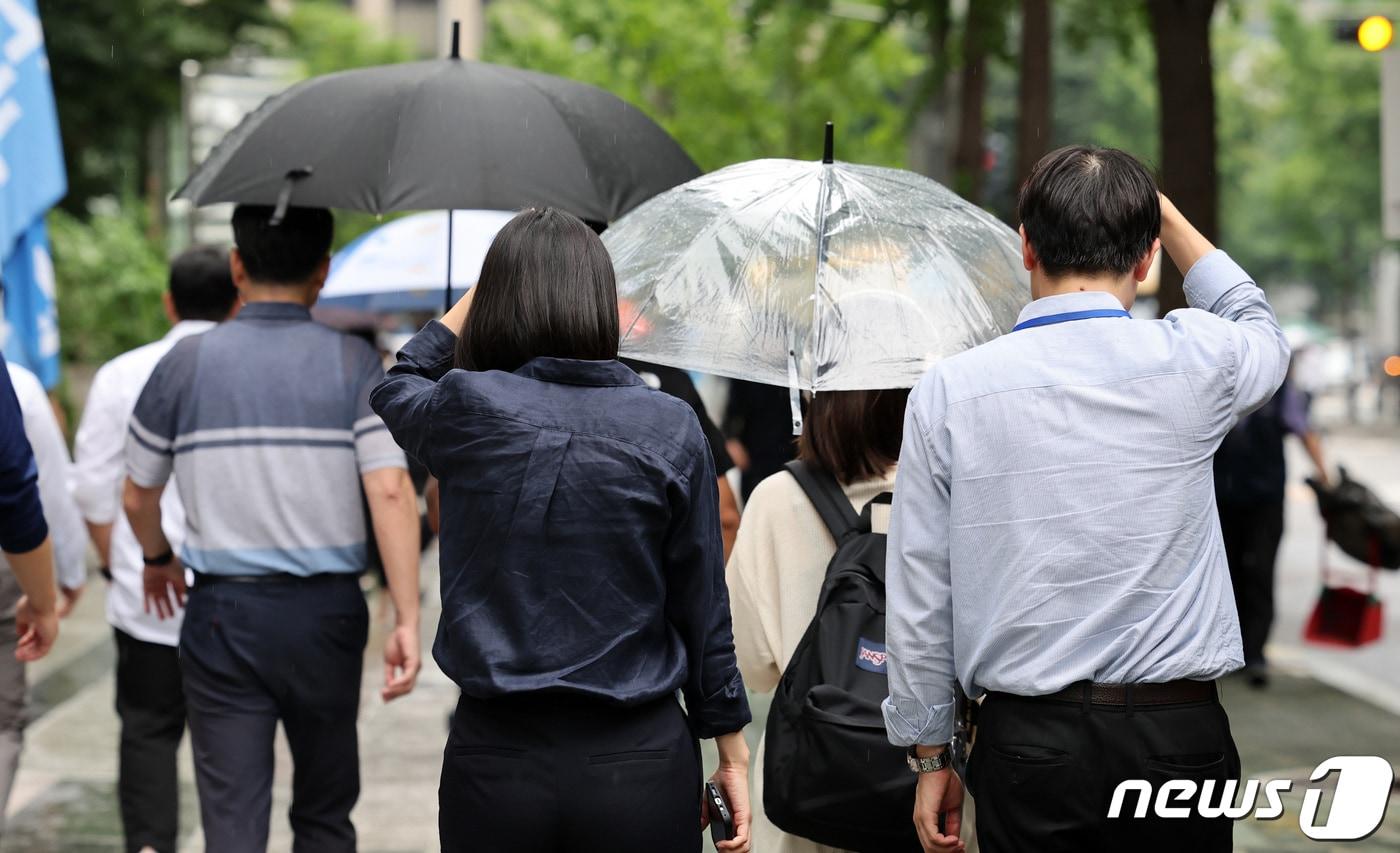 가을을 재촉하는 소나기가 내린 30일 서울 영등포구 여의도 일대에서 우산을 미처 챙기지 못한 시민들이 손으로 머리를 가린 채 발걸음을 재촉하고 있다. 2023.8.30/뉴스1 ⓒ News1 김성진 기자