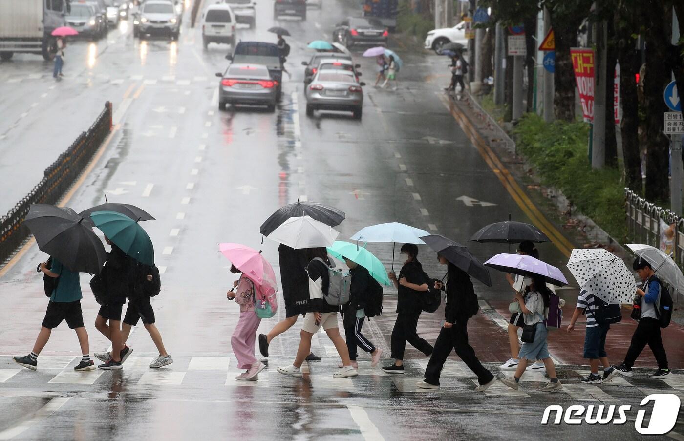 대구 북구 한 초등학교 앞에서 하굣길 우산을 쓴 학생들이 횡단보도를 건너고 있다. 2023.9.21/뉴스1 ⓒ News1 공정식 기자