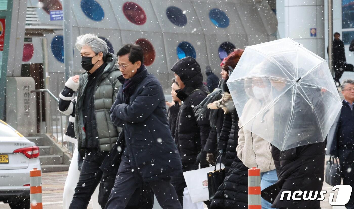 광주와 전남 7개 시군&#40;나주·목포·영암·무안·함평·장성·영광&#41;에 대설주의보가 내려진 22일 오후 광주시 광산구 송정역앞에서 시민들이 눈을 맞으며 걷고 있다.2024.1.22/뉴스1 ⓒ News1 김태성 기자