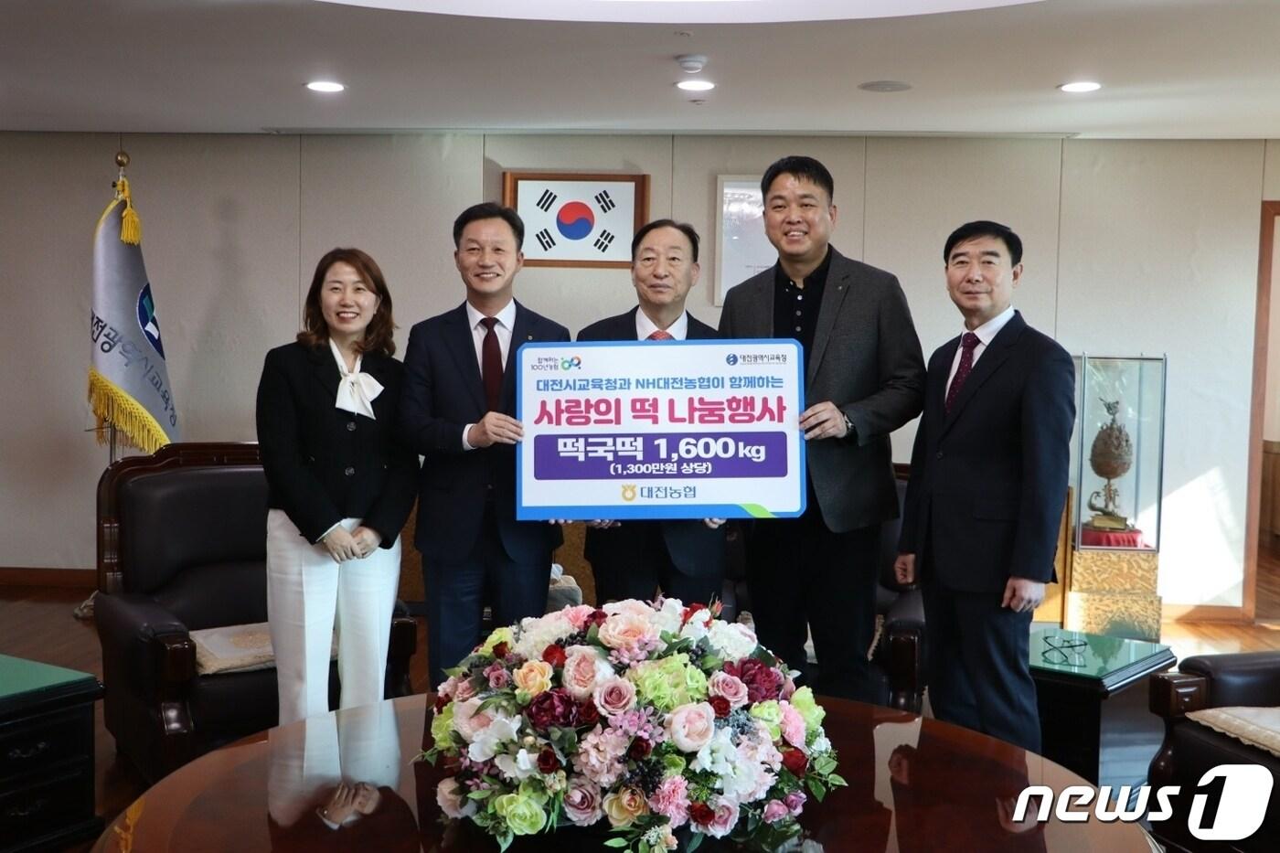 대전농협 사회봉사단 이재윤 공동위원장&#40;왼쪽 두번째&#41;과 권희근 공동위원장&#40;오른쪽 두번째&#41;이 떡국 떡을 설동호 대전시교육감&#40;가운데&#41;에게 전달한 후 기념사진을 찍고 있다.&#40;농협 대전본부 제공&#41; / 뉴스1