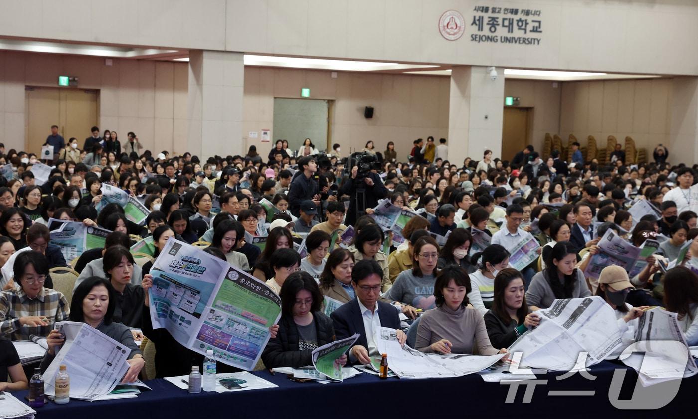 15일 서울 광진구 세종대학교에서 열린 종로학원 2025 정시 합격점수 예측 및 전략 설명회에서 학부모들이 정시모집 배치 참고표를 보며 설명을 듣고 있다. 2024.11.15/뉴스1 ⓒ News1 김명섭 기자