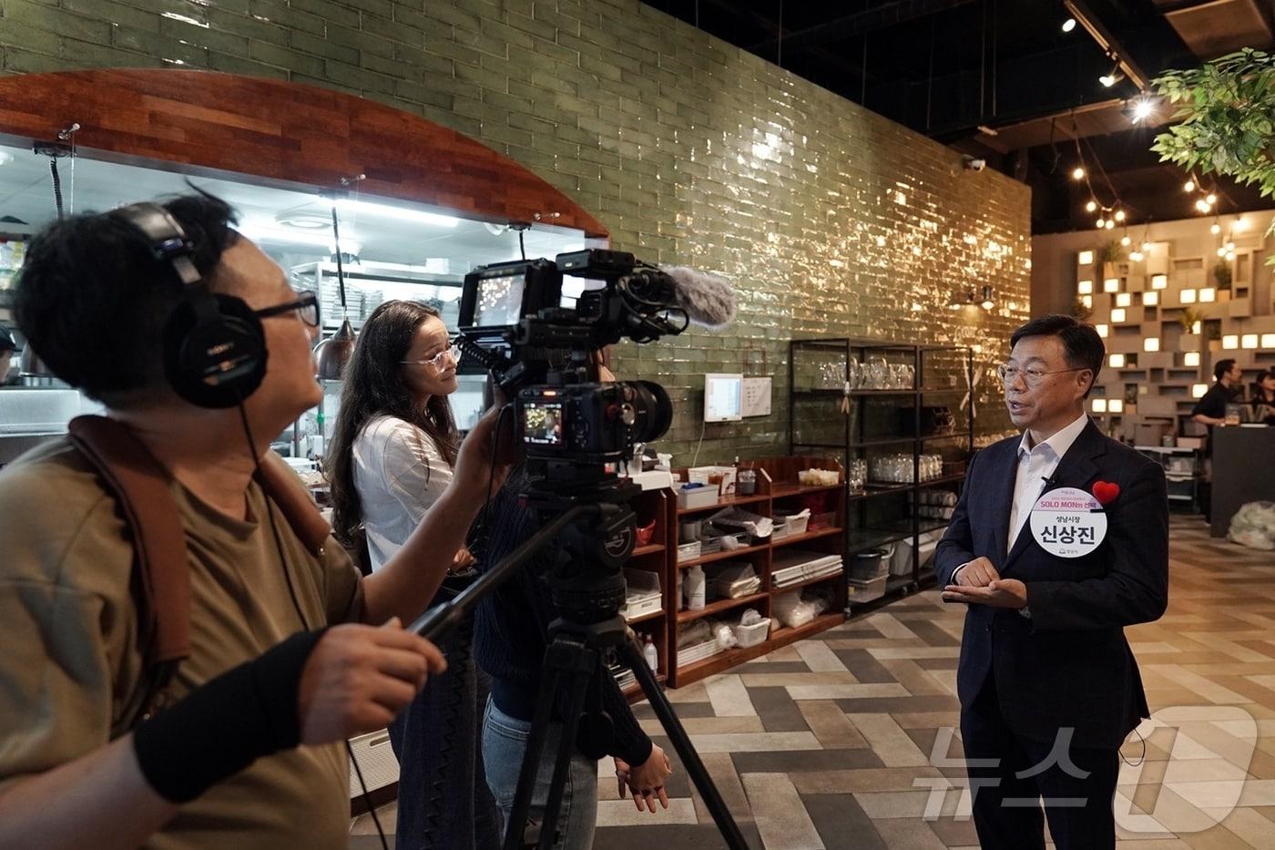 지난 16일 탭퍼블릭 판교점&#40;분당구 백현동&#41;에서 열린 경기 성남시의 7차 ‘솔로몬의 선택’ 행사에서 31쌍의 커플이 탄생했다. 사진은 신상진 시장이 당시 행사장에서 영국 BBC 취재팀과 인터뷰를 하고 있는 모습.&#40;성남시 제공&#41;/