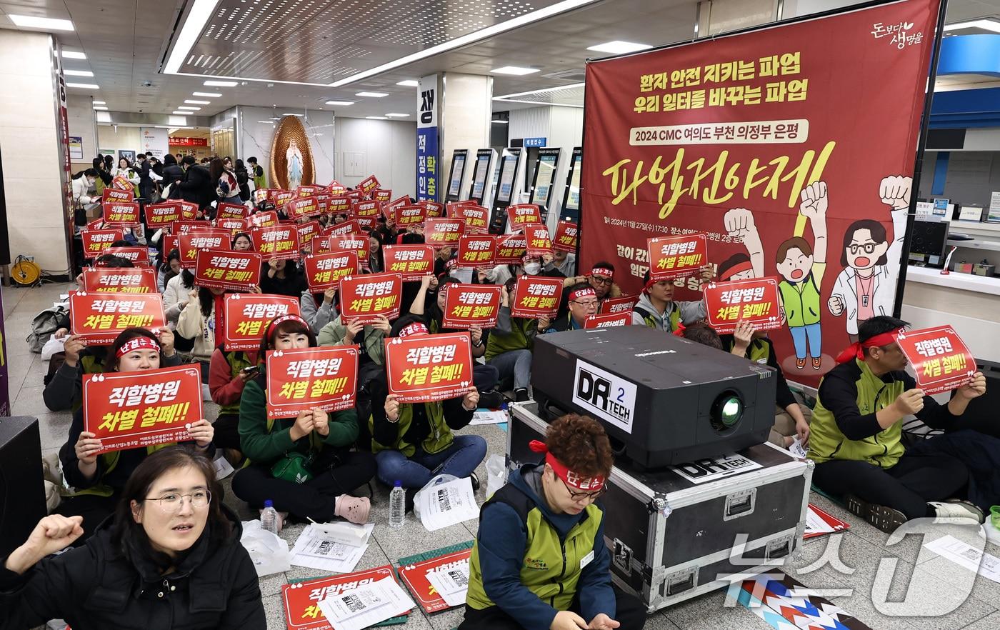 27일 오후 서울 가톨릭대학교 여의도성모병원에서 열린 가톨릭중앙의료원&#40;CMC&#41; 소속 4개병원지부 파업전야제에서 조합원들이 요구사항이 적힌 피켓을 들고 구호를 외치고 있다. 2024.11.27/뉴스1 ⓒ News1 구윤성 기자