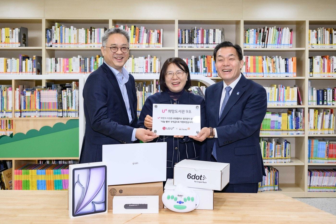 수원 아름학교 U+희망도서관 건립을 기념해 &#40;왼쪽부터&#41;박경중 LG유플러스 대외협력담당, 신영숙 수원 아름학교장, 이재준 수원시장이 현판을 들고 있는 모습.&#40;LG유플러스 제공&#41;