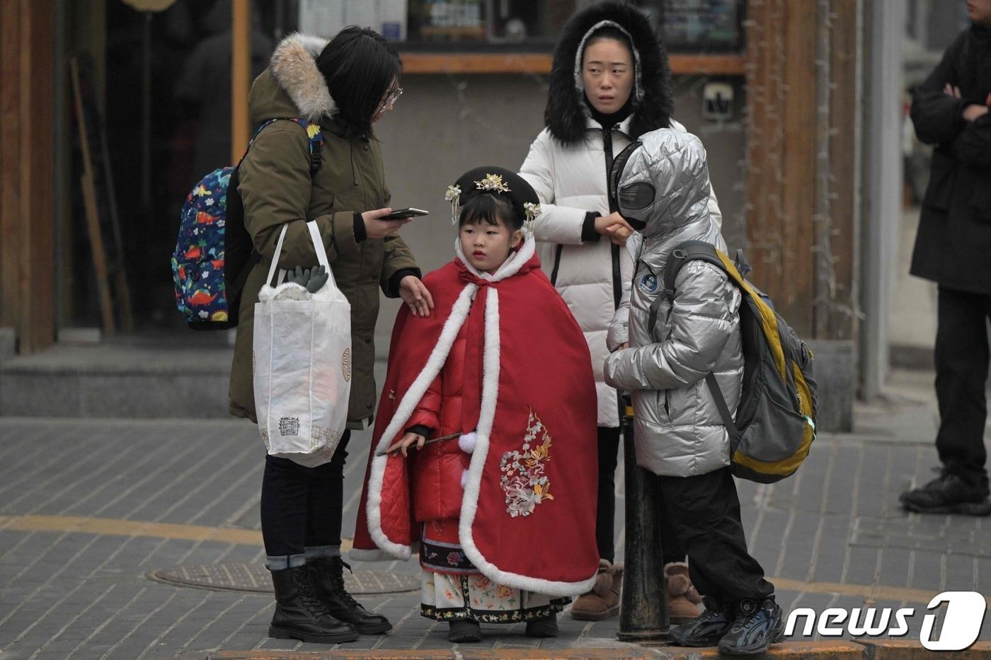 17일 베이징의 한 거리에 엄마와 아이가 서있다. 2024.1.7 ⓒ AFP=뉴스1 ⓒ News1 정은지 특파원