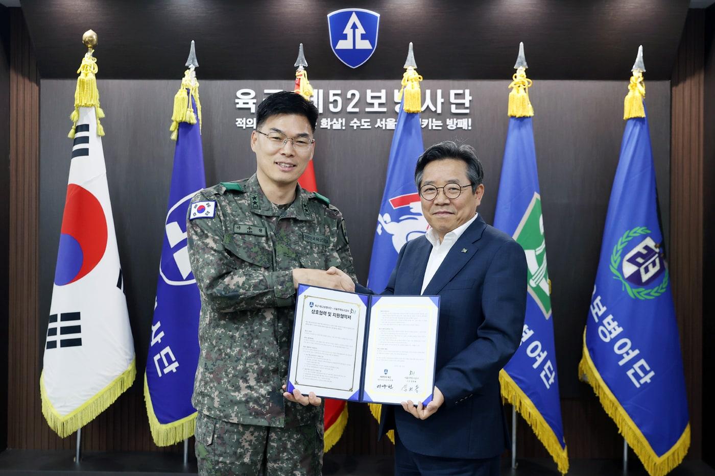 김헌동 SH공사 사장&#40;오른쪽&#41;과 이우헌 육군 제52보병사단장이 업무협약 체결 후 협약서를 들어보이고 있다.