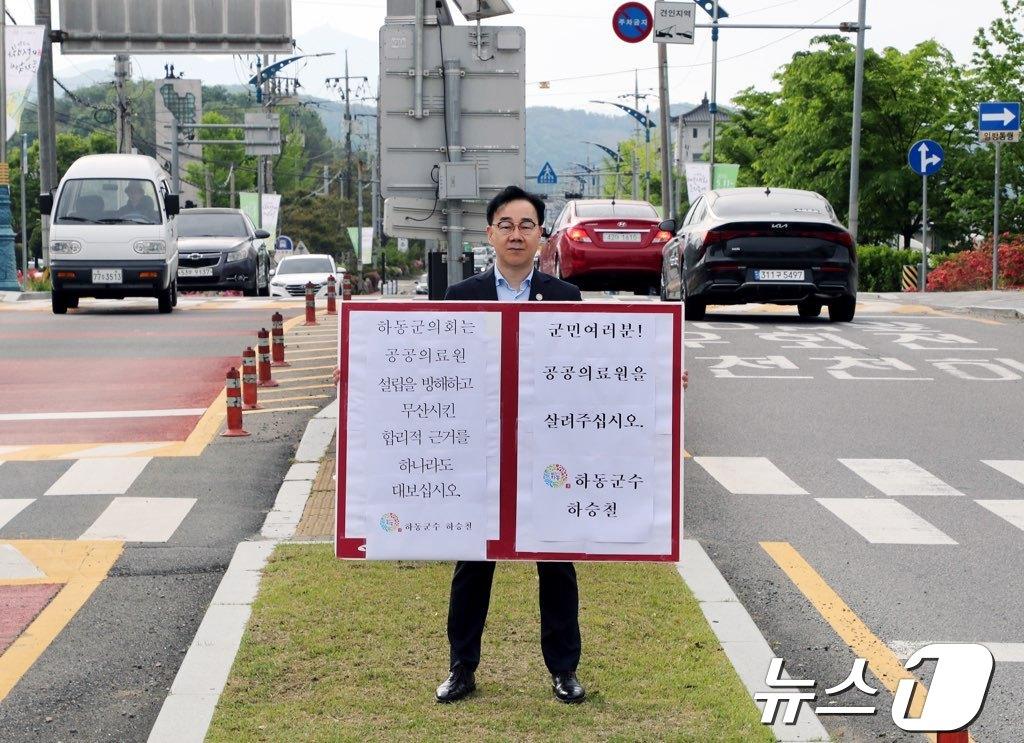 26일 하승철 하동군수가 군의회의 ‘보건의료원 실시 설계비’ 전액 삭감을 규탄하는 피켓을 들고 있다.&#40;하동군 제공&#41;