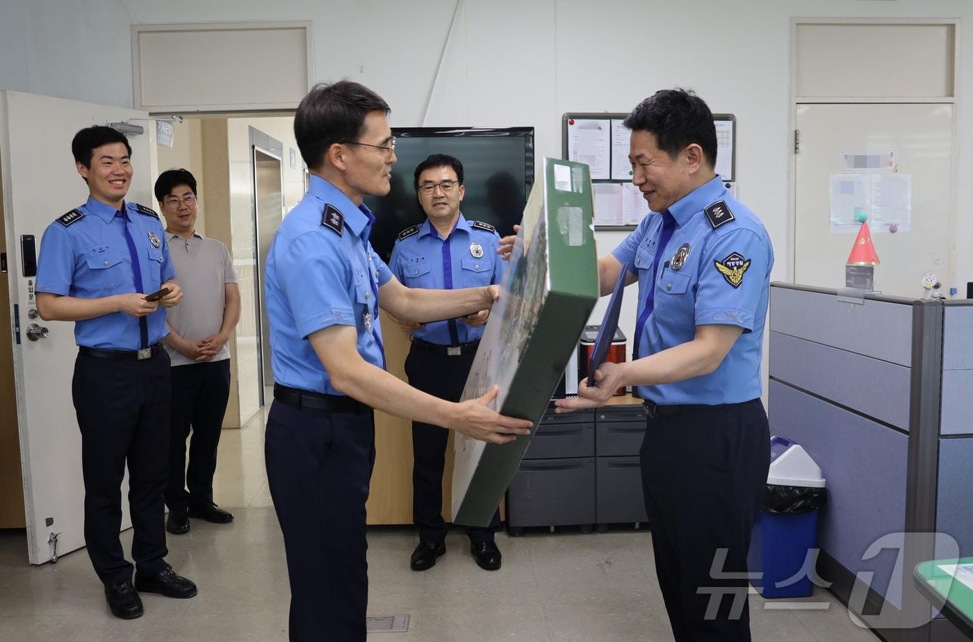 김성종 동해해경청장&#40;사진 왼쪽&#41;이 10일 기획운영계 김병주 경사를 찾아 출산을 축하하고 선물을 건네고 있다.&#40;동해해경청 제공&#41; 2024.6.11/뉴스1