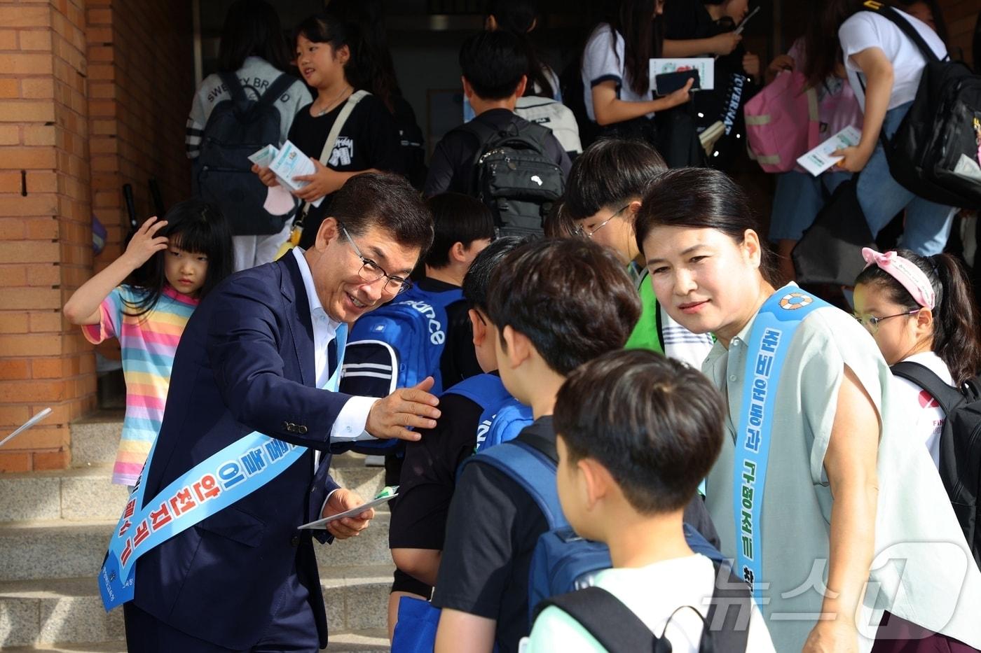 17일 윤건영 충북교육감이 동주초등학교 정문에서 동주초 교육 3주체와 청주교육지원청이 참여한 가운데 여름철 물놀이 안전사고 예방 캠페인을 하고 있다.&#40;충북교육청 제공&#41;/뉴스1