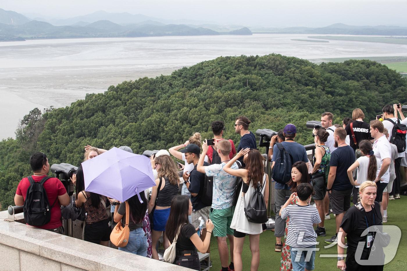 북한이 9번째 대남 오물풍선을 살포한 21일 경기 파주시 오두산통일전망대를 찾은 관광객들이 망원경으로 북녘땅을 바라보고 있다. 우리 군은 서부·중부·동부전선에 배치된 고정식 확성기를 릴레이식으로 돌아가며 제한적으로 방송하며 대응해오다 이번에 전방 지역 모든 확성기를 동시에 가동하는 방식으로 전환했다. 2024.7.21/뉴스1 ⓒ News1 유승관 기자