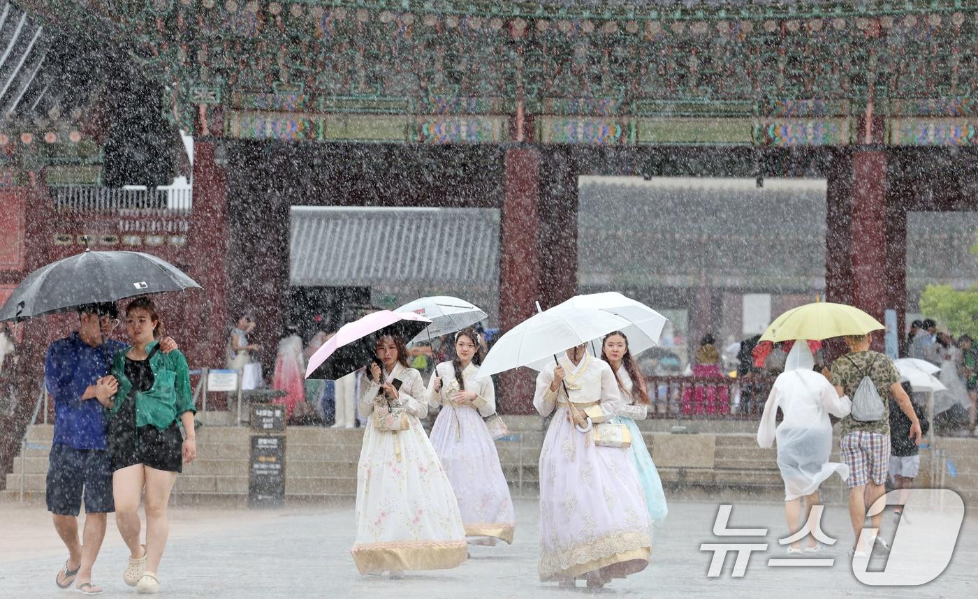 강풍을 동반한 많은 장맛비가 내린 22일 오후 서울 종로구 경복궁을 찾은 관광객들이 우산으로 비를 피하고 있다. 2024.7.22/뉴스1 ⓒ News1 장수영 기자