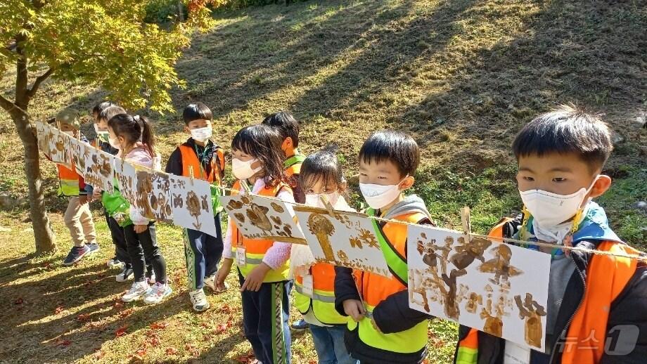 황새공원 탐방프로그램에 참가한 어린이들이 자신이 그린 그림을 줄에 걸고 있다. &#40;황새공원 홈페이지 갈무리&#41;/뉴스1 