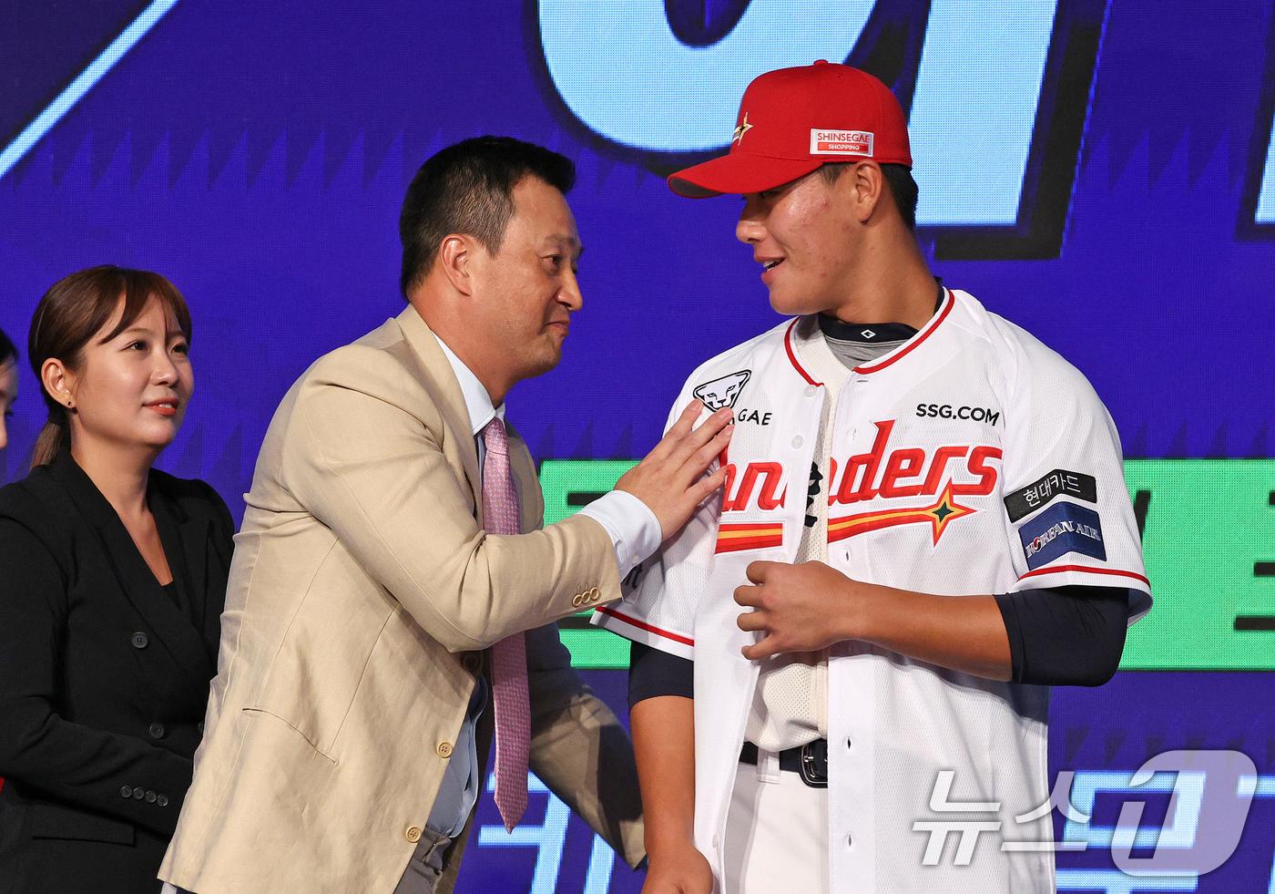 11일 오후 서울 송파구 롯데호텔 월드에서 열린 ‘2025 KBO 신인 드래프트’에서 SSG 1라운드 8순위로 지명된 이율예&#40;강릉고&#41;가 SSG 김재현 단장으로부터 유니폼을 받고 있다. 2024.9.11/뉴스1 ⓒ News1 장수영 기자