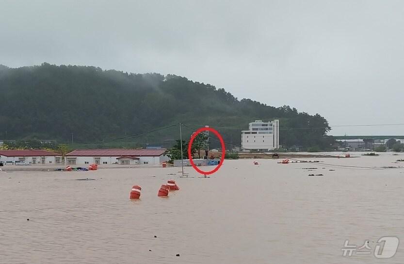 21일 김해시 신문동 마찰교 인근 농막 지붕 위에 고립된 60대 남성이 구조를 요청하고 있다.&#40;경남소방본부 제공&#41;