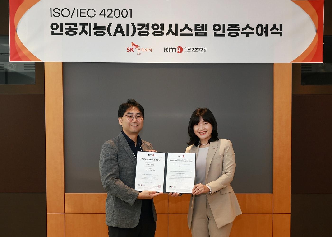 이달 27일 경기도 성남시 분당구 SK u-타워에서 진행된 &#39;AI경영시스템&#40;ISO/IEC42001&#41; 인증 수여식&#39;. 왼쪽부터 차지원 SK C&C AIX 사업1그룹장과 황은주 한국경영인증원&#40;KMR&#41; 대표.&#40;SK C&C 제공&#41;